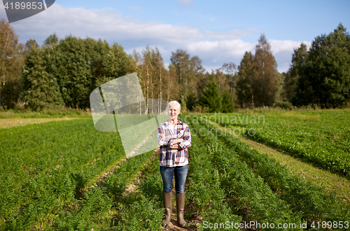 Image of happy senior woman at farm