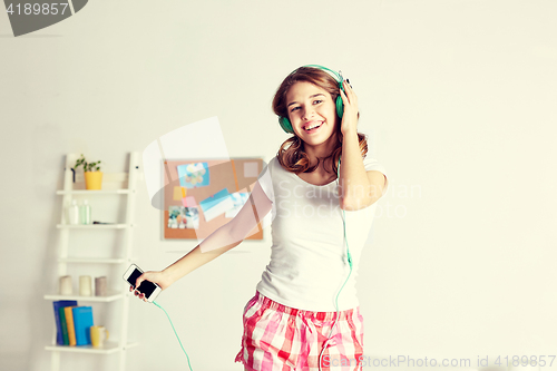 Image of happy woman in headphones ihaving fun at home