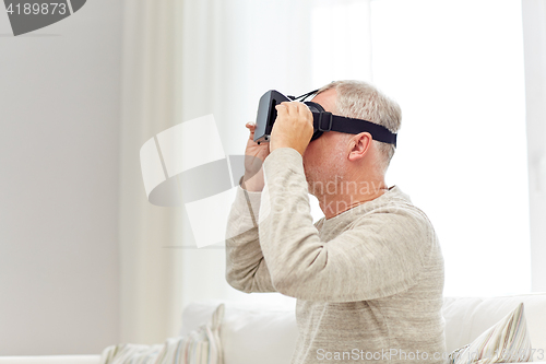 Image of old man in virtual reality headset or 3d glasses