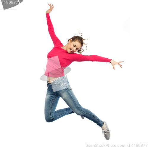 Image of happy young woman jumping in air or dancing