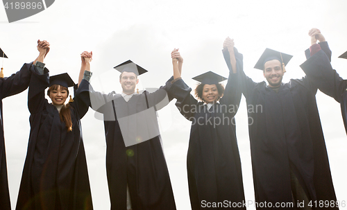 Image of happy students or bachelors celebrating graduation