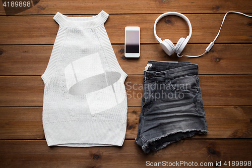 Image of clothes and smartphone with headphones