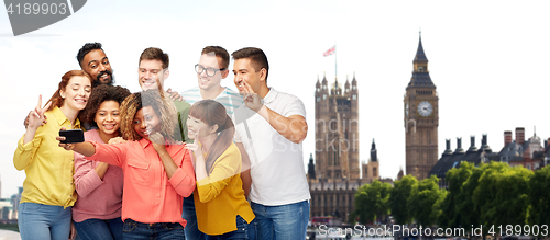 Image of people taking selfie by smartphone in london