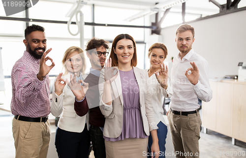 Image of happy business team in office