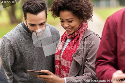 Image of happy friends with smartphone outdoors