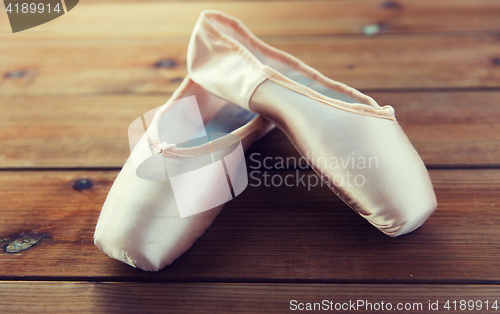 Image of close up of pointe shoes on wooden floor