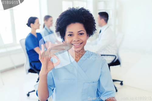 Image of doctor or nurse showing ok hand sign at hospital