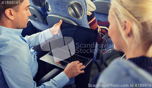 Image of close up of passengers with laptop in travel bus