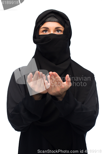 Image of praying muslim woman in hijab over white