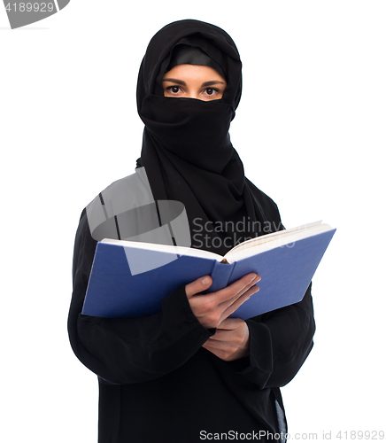 Image of muslim woman in hijab reading book over white