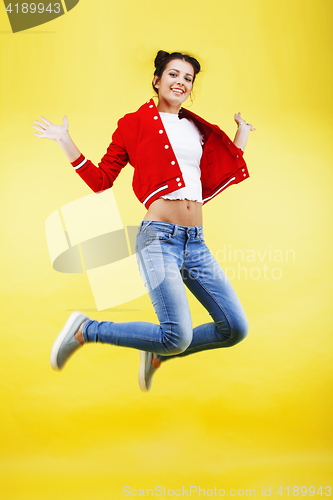 Image of young pretty brunette girl jumping isolated on yellow background, lifestyle flying people concept close up