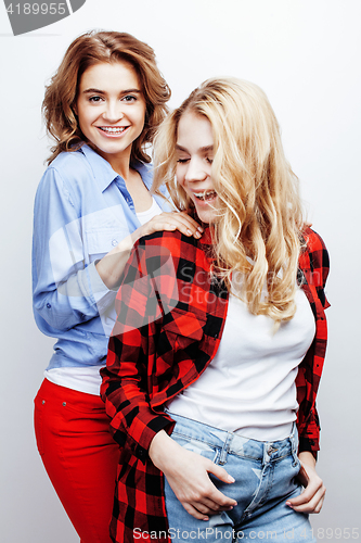 Image of two pretty blond woman having fun together on white background, mature mother and young teenage daughter, lifestyle people concept