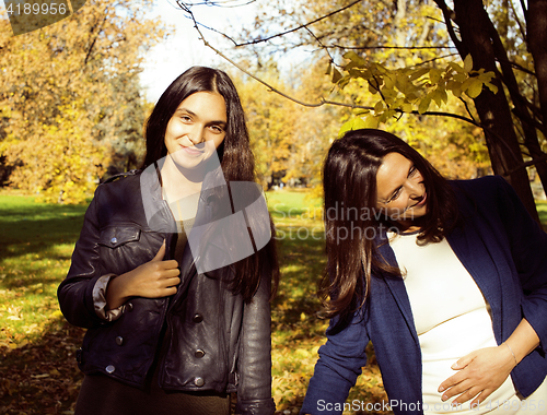 Image of mature real mother with daughter outside autumn fall in park