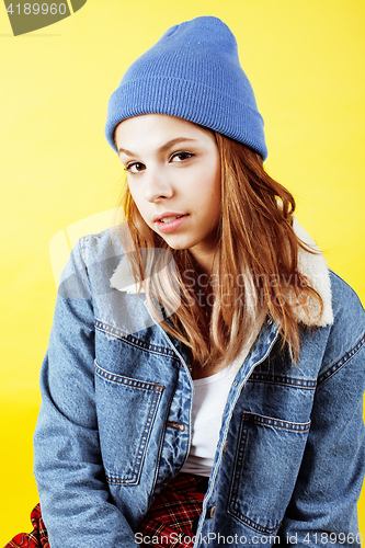 Image of young pretty teenage girl posing emotional on yellow background, lifestyle people concept