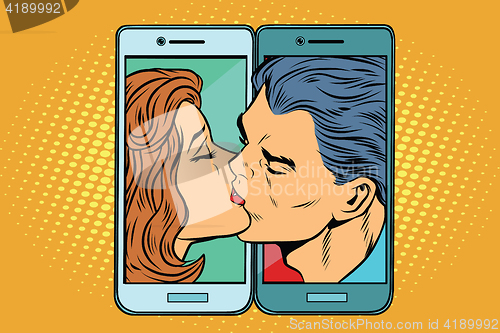 Image of Retro man and woman kissing through a smartphone