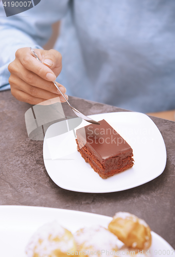 Image of Woman eating chocolate cake