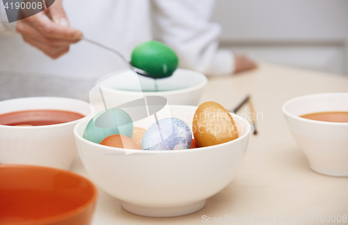 Image of Woman preparing Easter eggs