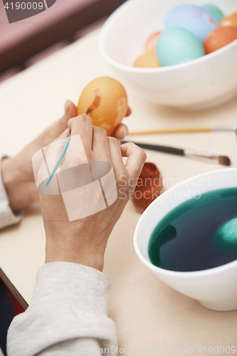 Image of Woman preparing Easter eggs