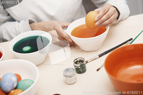 Image of Woman preparing Easter eggs