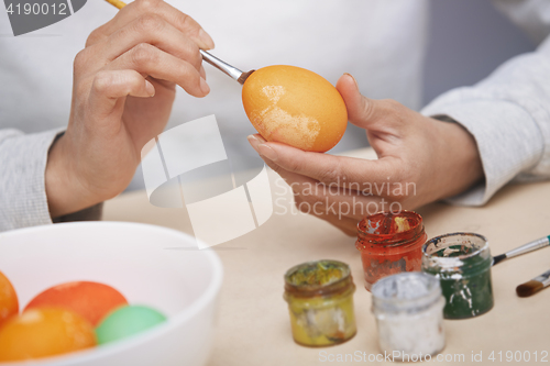 Image of Woman preparing Easter eggs