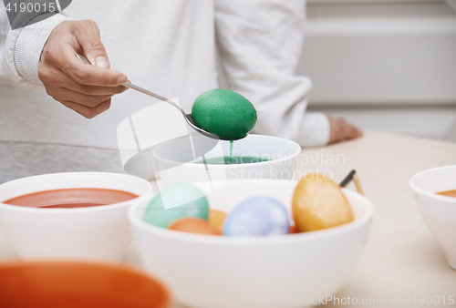 Image of Woman preparing Easter eggs