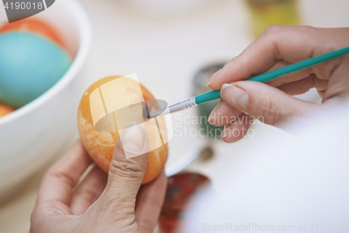 Image of Woman preparing Easter eggs