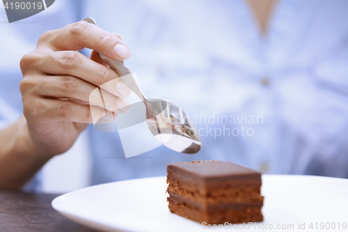 Image of Woman eating chocolate cake