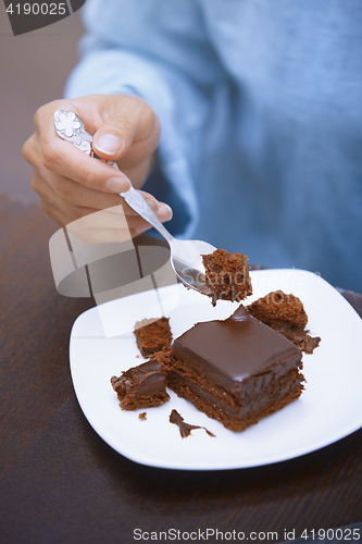 Image of Woman eating chocolate cake 