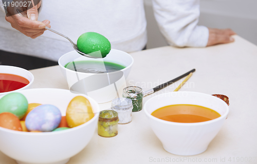 Image of Woman preparing Easter eggs