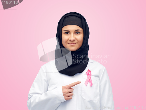 Image of muslim doctor with breast cancer awareness ribbon