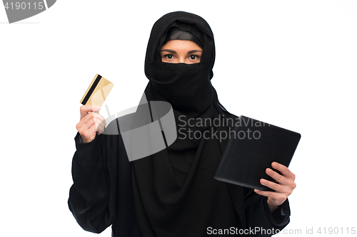 Image of woman in hijab with tablet pc and credit card