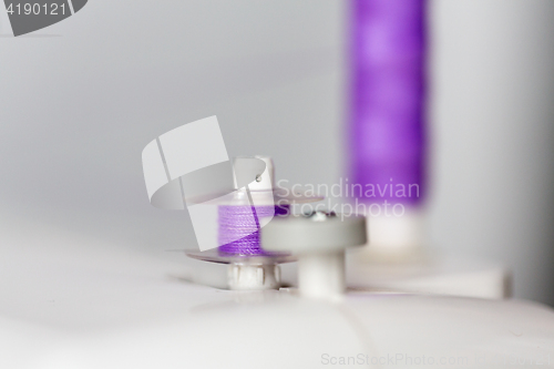 Image of thread spools on sewing machine