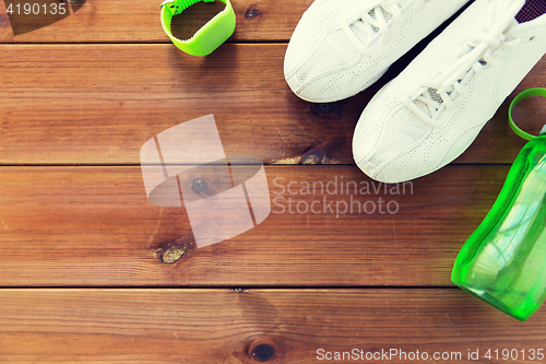 Image of close up of sneakers, bracelet and water bottle