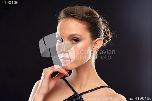 Image of beautiful young asian woman over black background