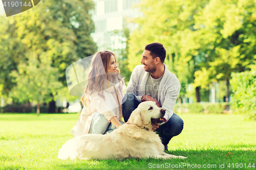 Image of happy couple with labrador dog walking in city