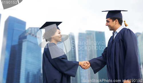 Image of happy students or bachelors greeting each other