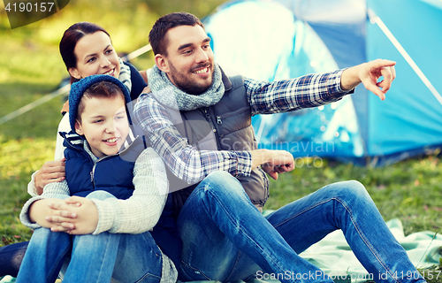 Image of happy family with tent at camp site