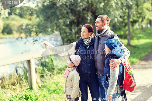 Image of happy family with backpacks hiking