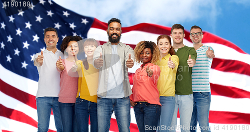 Image of international group of people showing thumbs up