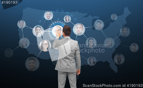 Image of businessman touching virtual screen with contacts