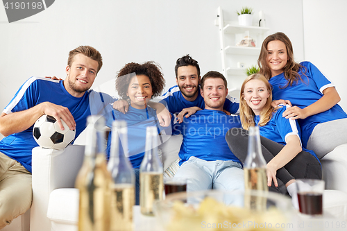 Image of friends or football fans with beer at home