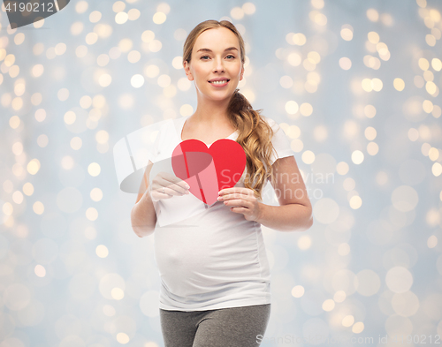 Image of happy pregnant woman with red heart