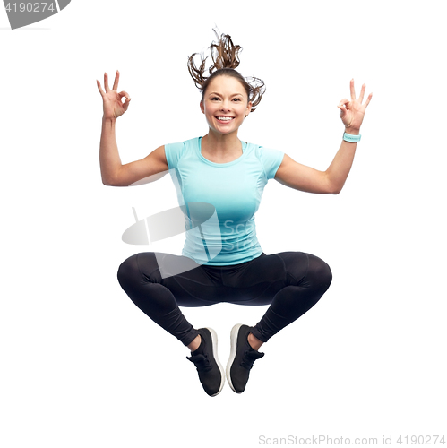 Image of happy smiling sporty young woman jumping in air