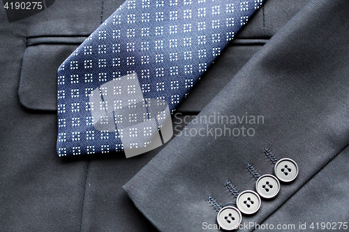 Image of close up of business suit jacket and tie