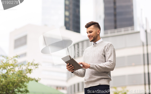 Image of happy man with tablet pc computer in city