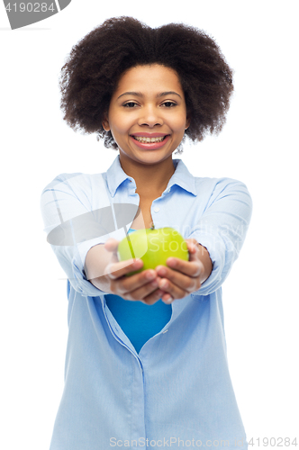 Image of happy african american woman with green apple