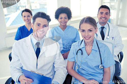 Image of group of happy doctors on seminar at hospital