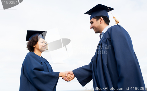 Image of happy students or bachelors greeting each other