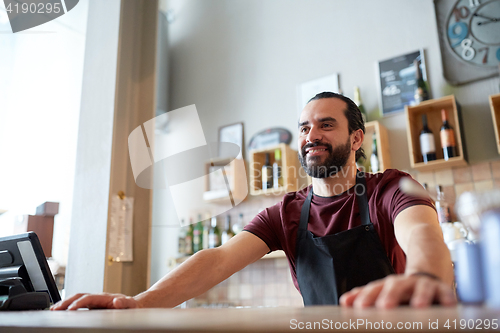 Image of happy man or waiter at bar or coffee shop