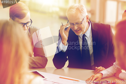 Image of architects with tablet pc and blueprint at office